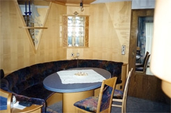 Wohnk&uuml;che; Essbereich mit ovaler Bank, Wandvert&auml;felung mit beleuchteten Eckvitrinen